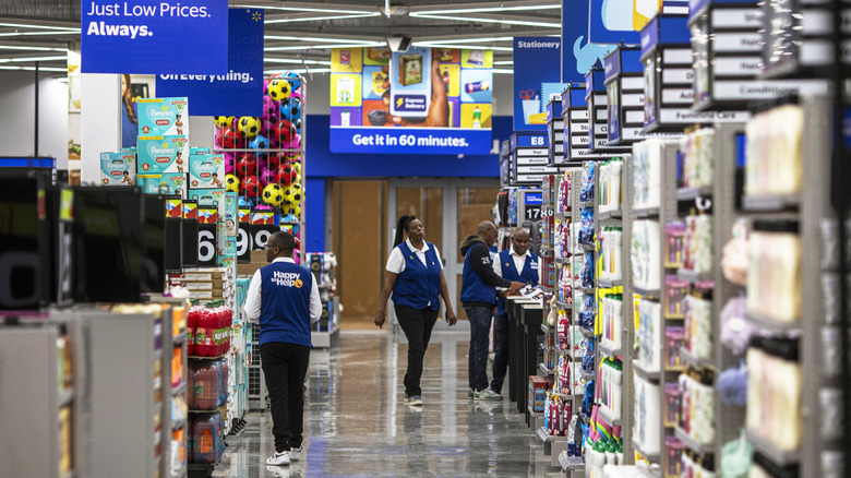 Several Walmart employees at the end of an aisle