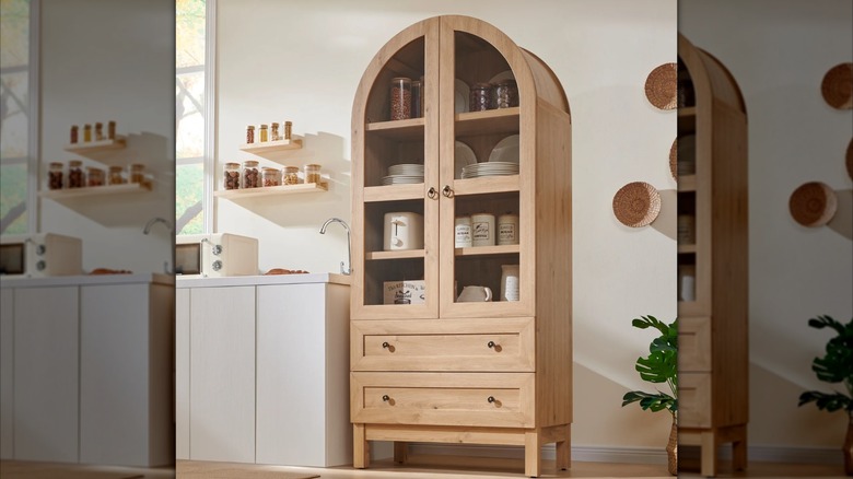 SinCiDo Arched Kitchen Pantry Storage Cabinet in a natural wood color filled with dishes and canisters