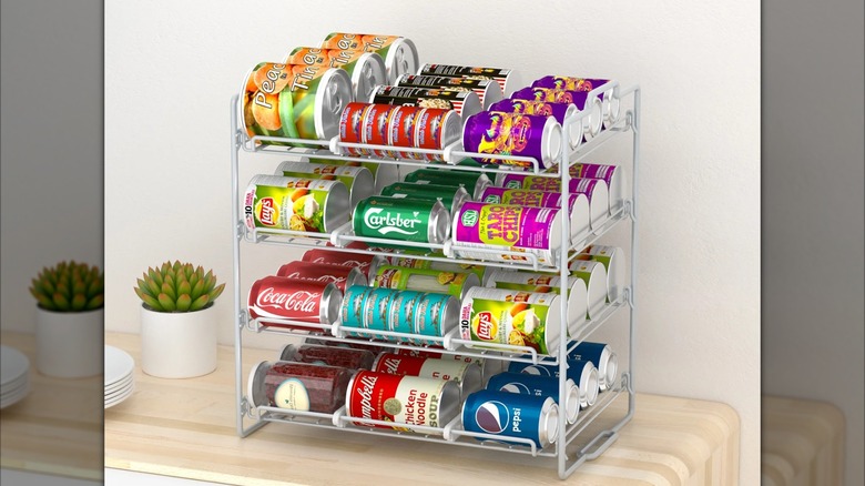 Stusgo Four-Tier Stackable Can Rack Organizer with an assortment of soup, soda, and beer cans