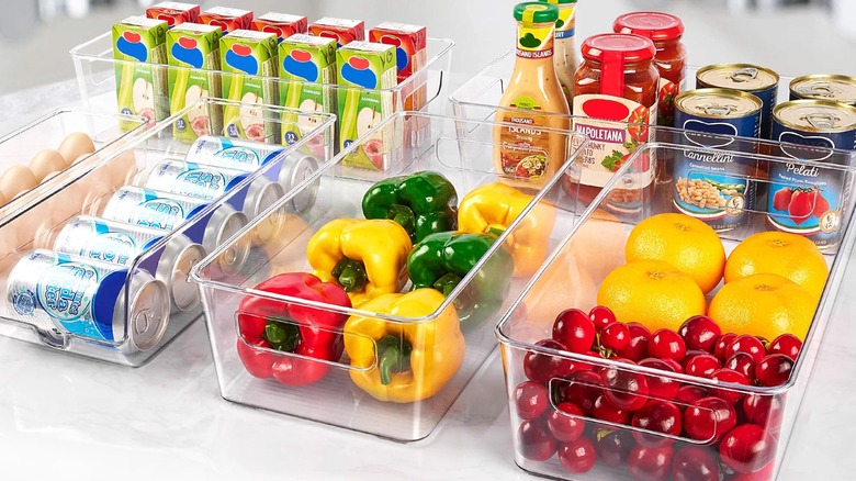 Vtopmart's set of clear storage bins with eggs, cans, peppers, fruit, juice boxes, and jars