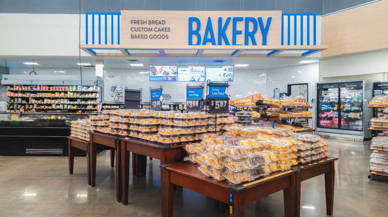 Walmart's bakery aisle with tables of pastries in boxes