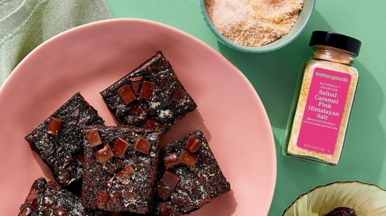 Plate of brownies beside jar of bettergoods salted caramel pink Himalayan salt
