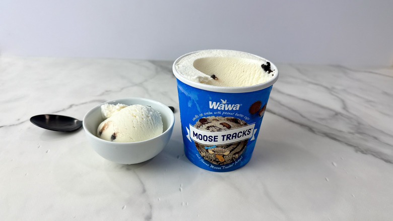 Wawa moose tracks ice cream carton and scoop in a bowl with a spoon