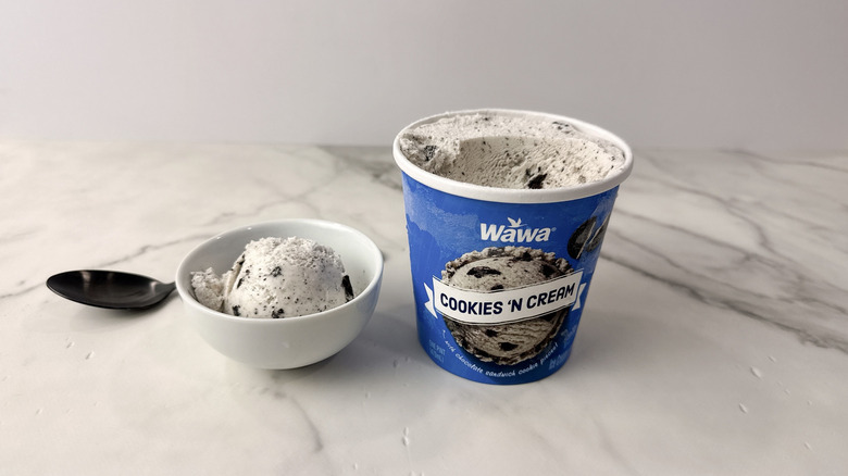 Wawa cookies 'n cream ice cream carton and scoop in a bowl with a spoon