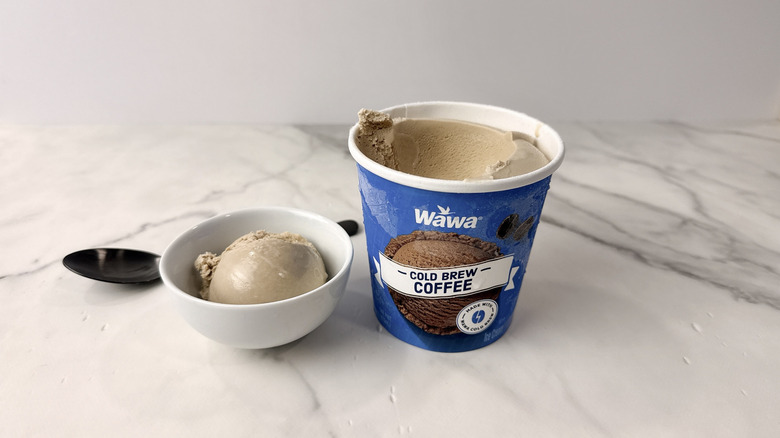 Wawa cold brew coffee ice cream carton and scoop in a bowl with a spoon