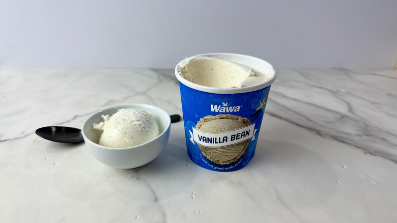 Wawa vanilla bean ice cream carton and scoop in a bowl with a spoon