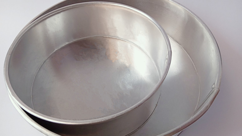 two aluminum round cake pans of different sizes