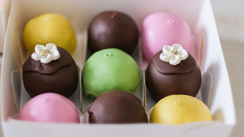 Beautifully decorated cake pops in a gift box, showing how leftover cake can be "upcycled" into a premium, profitable product