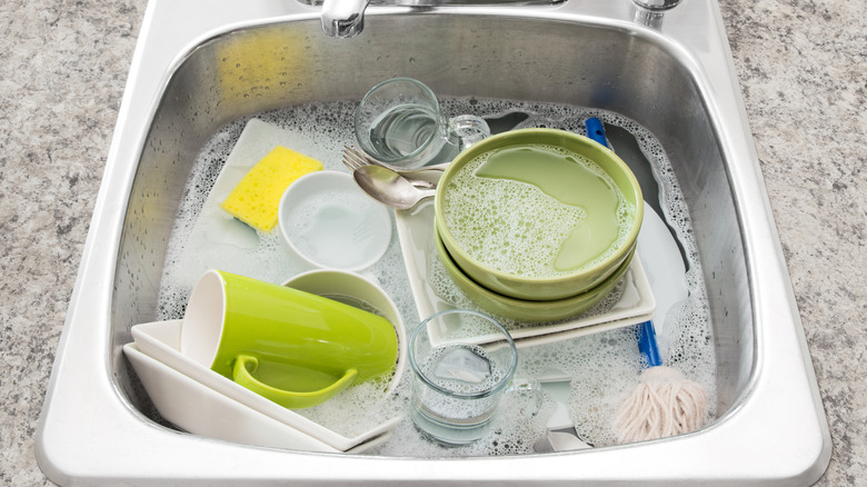 Sink full of dishes in soapy water