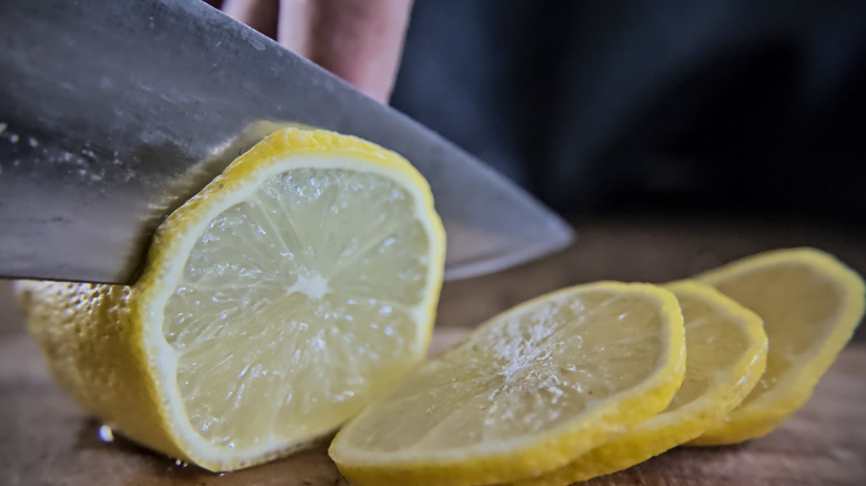 Slicing a lemon with a chef's knife