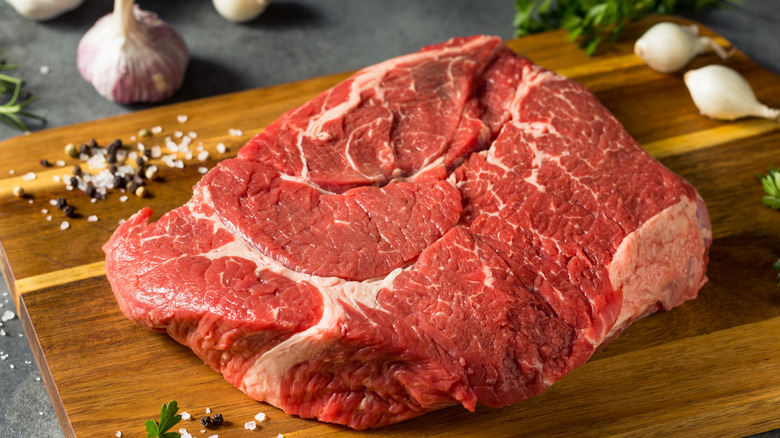 raw chuck roast on cutting board