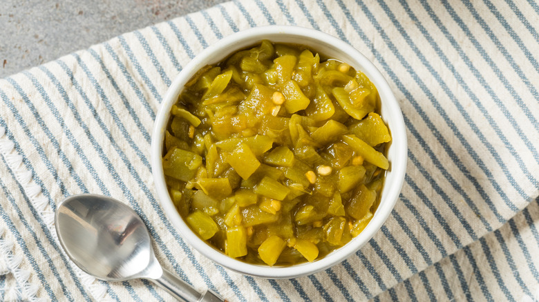 Diced green chilies in white bowl on towel