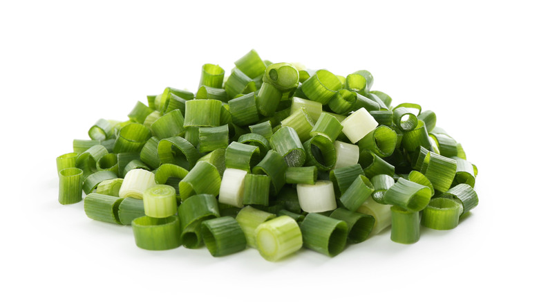 Chopped green onions on white background