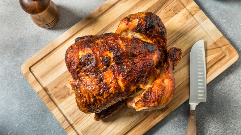 Rotisserie chicken on wooden cutting board