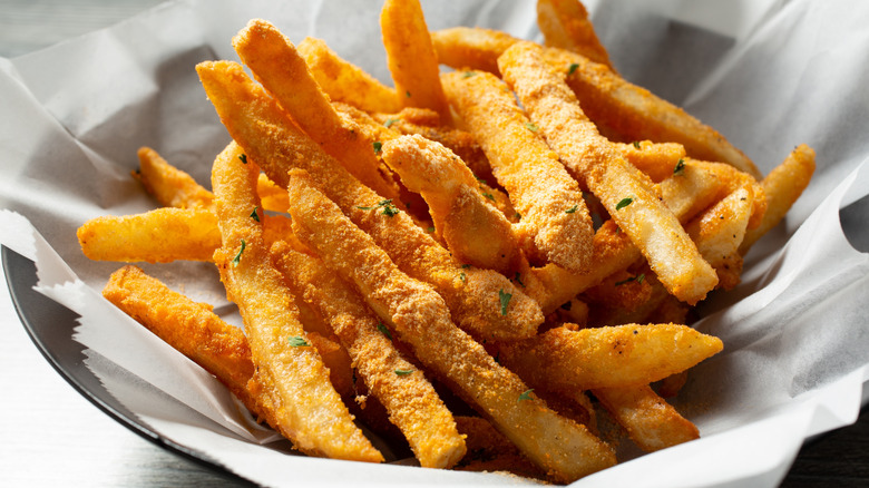 Bowl of french fries dusted with cheese powder