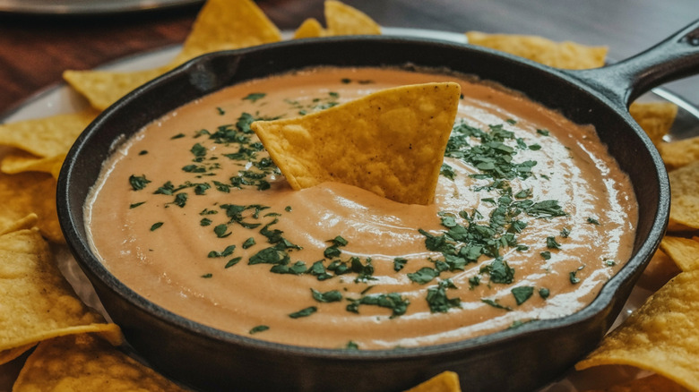 Cheesy dip in a skillet, served with tortilla chips