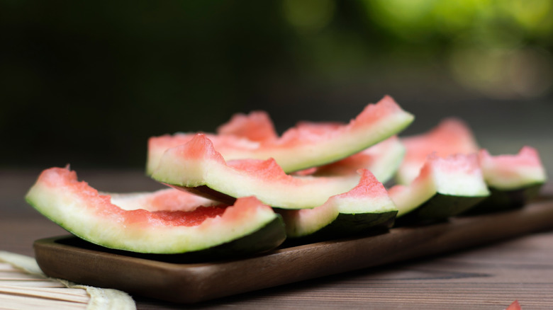 Eaten watermelon rinds stacked on a plate in the summer.