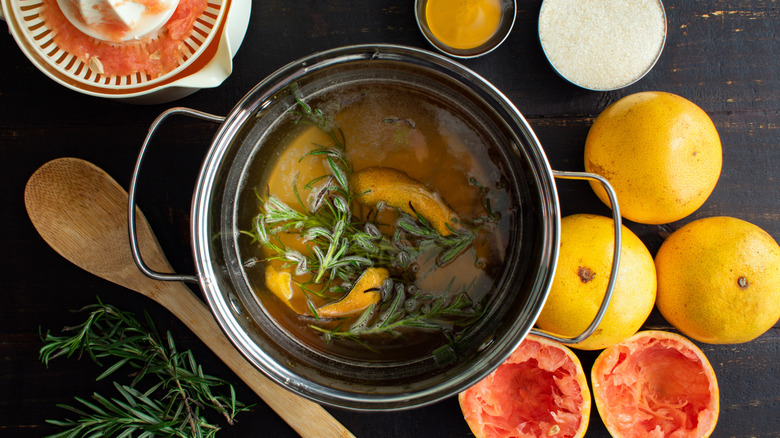 Aerial view of a pot of simple syrup infused with rosemary and grapefruit.