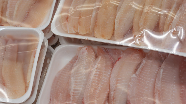 Packages of fish in a freezer section