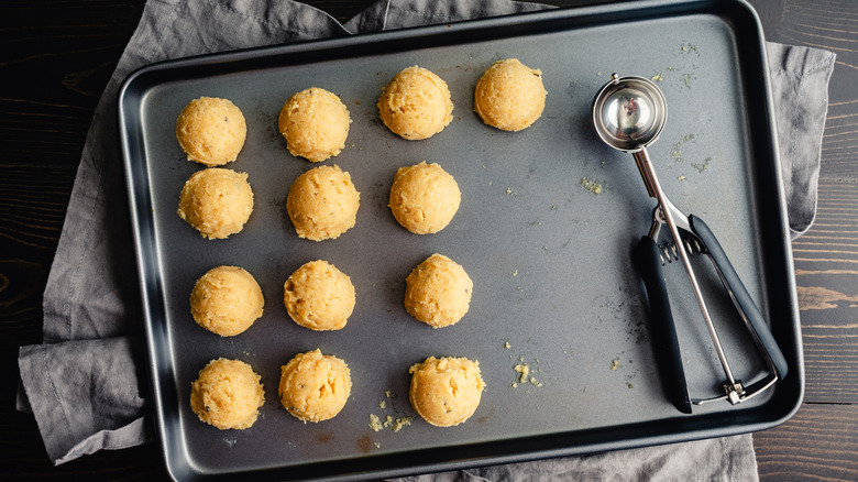 A tray of scooped cookie dough balls