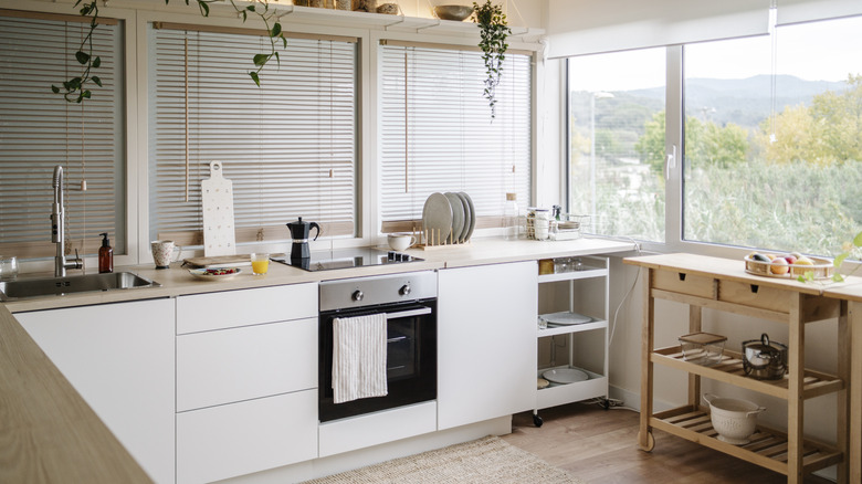 Small kitchen with integrated stove, oven, and shelves