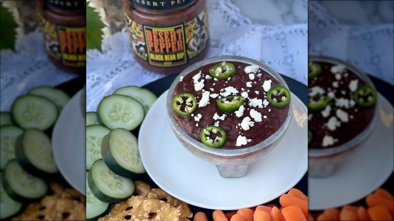 spicy black bean dip in a bowl with jalapeños