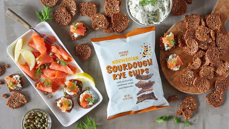 Trader Joe's Norwegian Sourdough Rye Chips surrounded by platters of food.