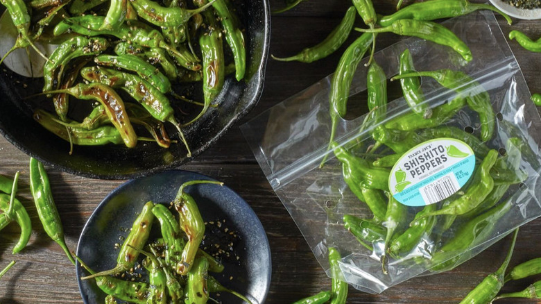 Trader Joe's shisito peppers on a wooden table.