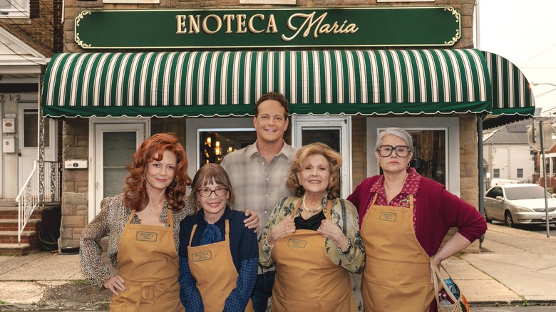 the cast of Nonnas outside of a restaurant