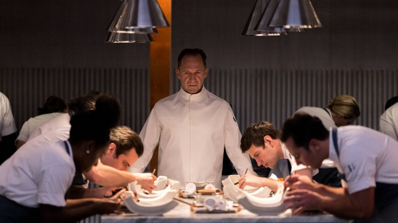 Ralph Fiennes watches chefs at work in The Menu