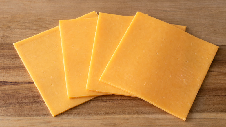 American cheese slices on cutting board