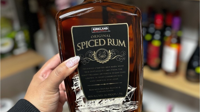 hand holding Kirkland spiced rum