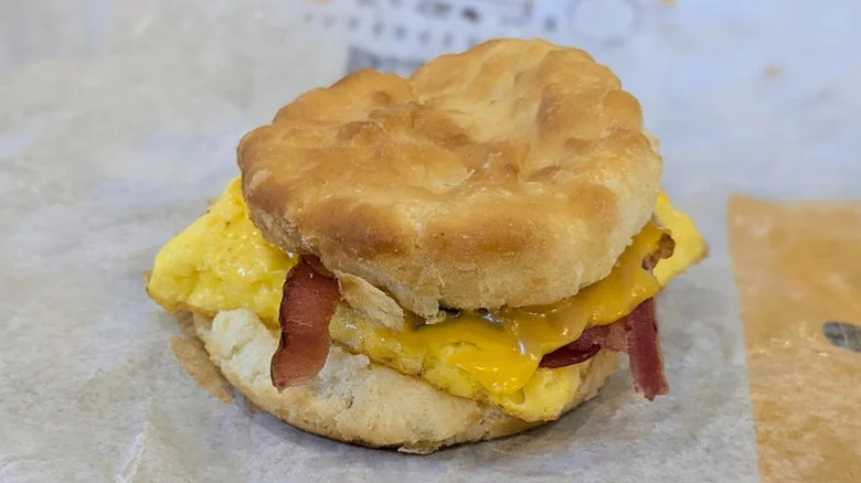 Burger King's Bacon Egg and Cheese Biscuit sitting on wax paper wrapping