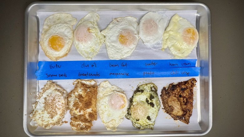 A variety of fried eggs on a sheet pan