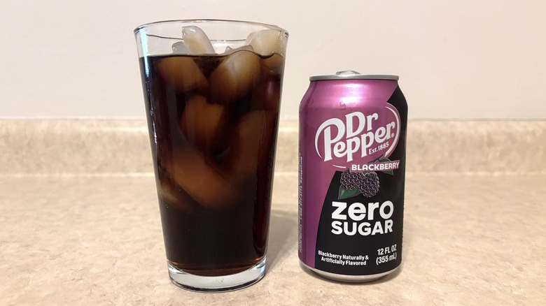 Dr Pepper Blackberry Zero in can and glass on neutral background.