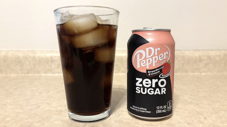 Dr Pepper Strawberries & Cream Zero in can and glass on neutral background.
