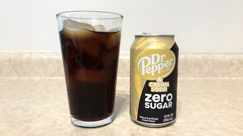 Dr Pepper & Cream Soda Zero in can and glass on neutral background.