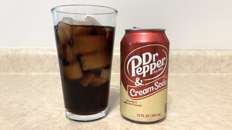 Dr Pepper & Cream Soda in can and glass on neutral background.