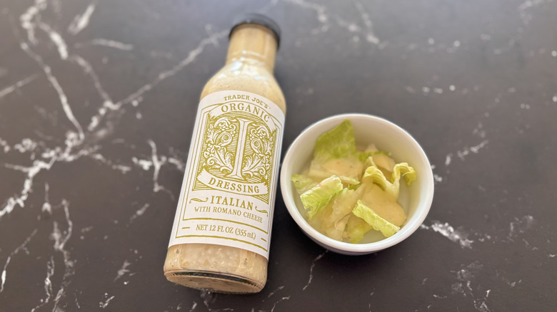 Trader Joe's Italian dressing bottle next to small bowl of salad