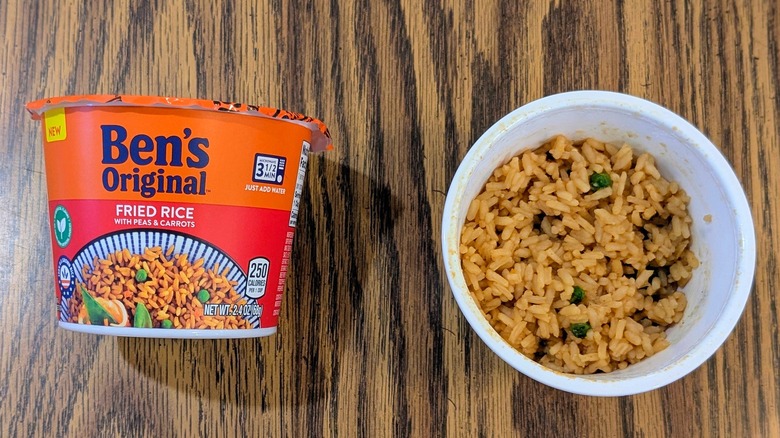 A top view of a plastic cup of fried rice next to a sealed cup of Ben's Original fried rice