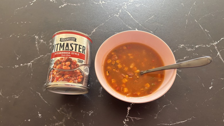 Progresso pitmaster soup can next to bowl of soup