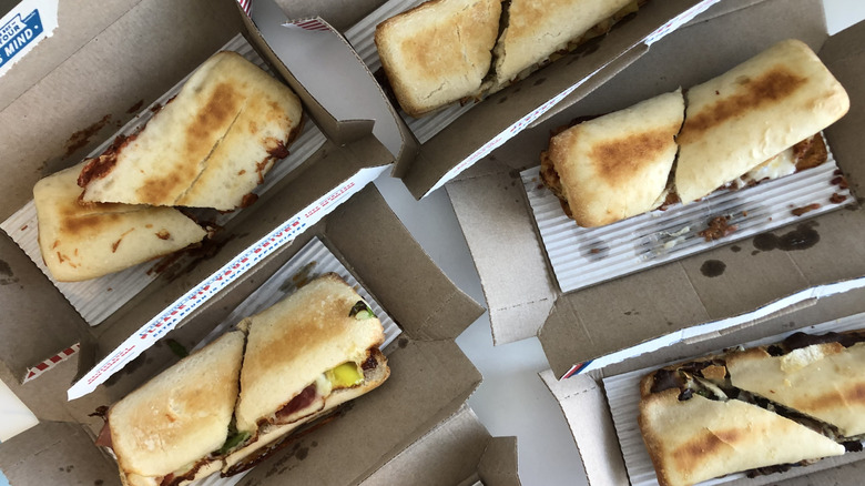 6 Domino's oven baked sandwiches in their boxes.