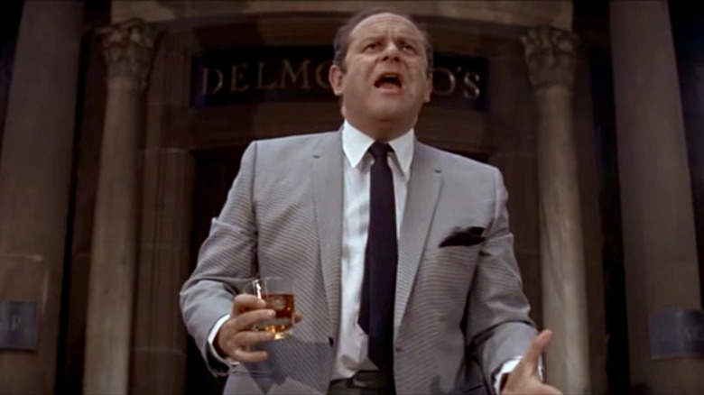 Jack Weston holding a drink outside of Delmonico's in the 1969 film "The April Fools"