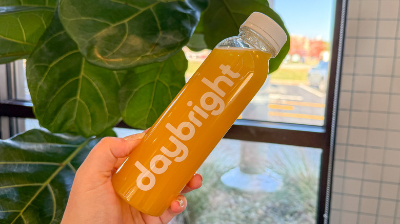 Bottle of Daybright Running Buddy in-hand