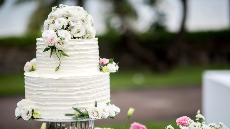 two tier white wedding cake with flowers