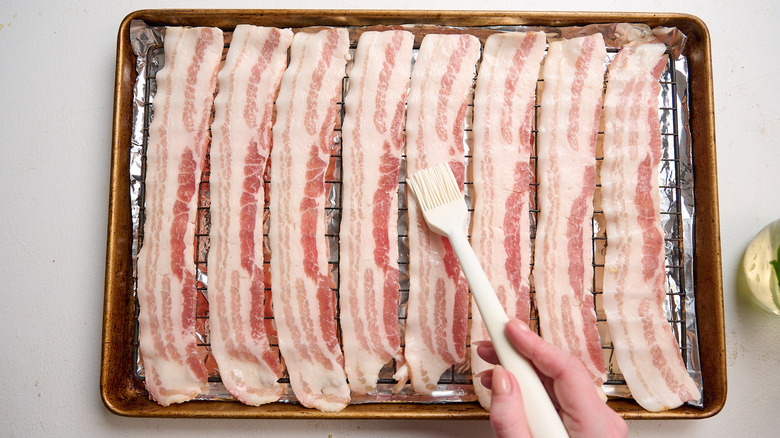 brushing syrup onto the bacon