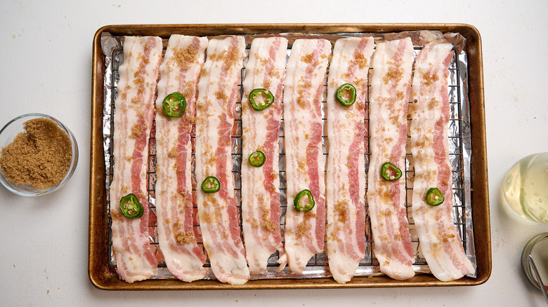topping slices of bacon with jalapeno