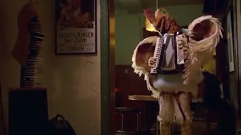 Subservient chicken playing an accordian commercial screen grab