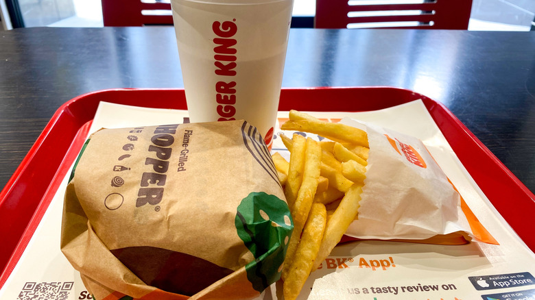 Wrapped Whoper, fries, and drink on red tray