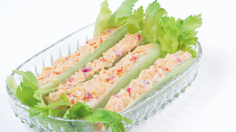 a plate with four stuffed celery stalks